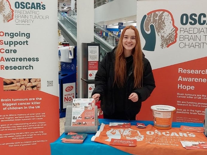 OSCAR's childrens charity volunteer in a supermarket raising brain tumour awareness